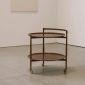Italian wooden bar trolley, 1960s, Mid-Century Modern design, set in a modern art gallery.