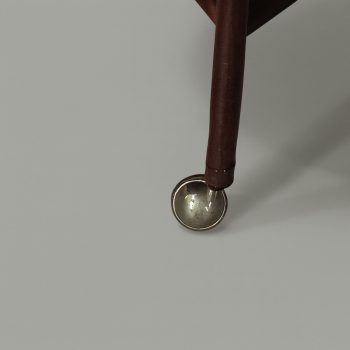 Detail of the brass wheels of the Italian wooden bar trolley, 1960s design.