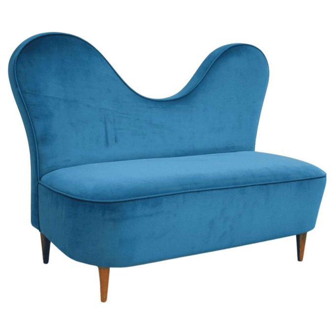 Sofa by Cesare Lacca in turquoise velvet on a neutral white background.