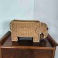 Italian woven rattan magazine rack in the shape of an elephant, on a vintage wooden cabinet, 1970s.